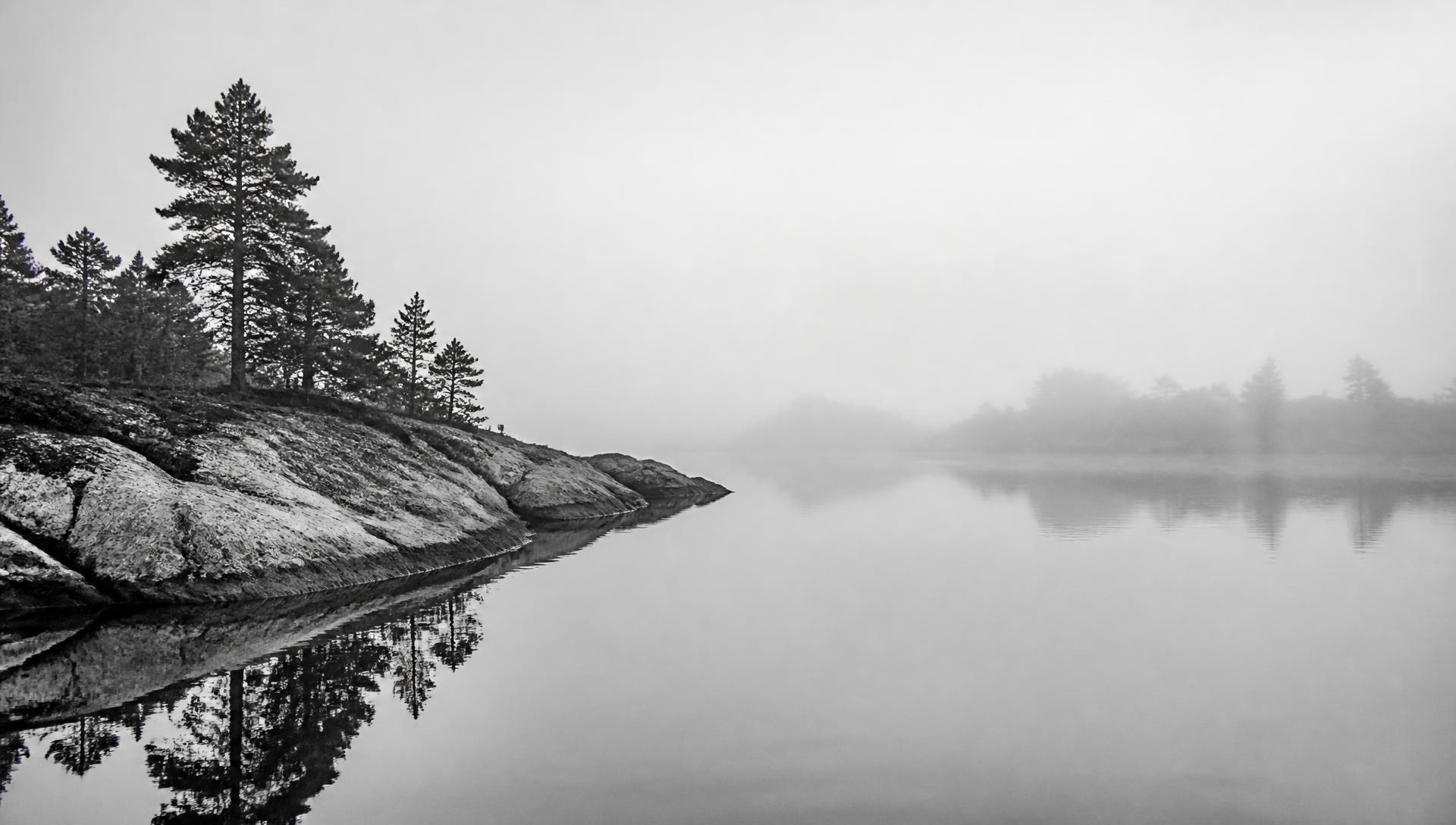 Black and white misty Finnish archipelago bay